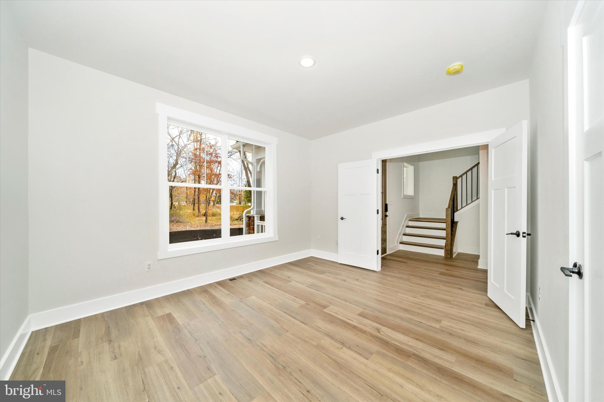 1154 Mt Zion Marlboro Road Lothian, MD 20711 - Photo 4 of 66 a view of an empty room with wooden floor and a window