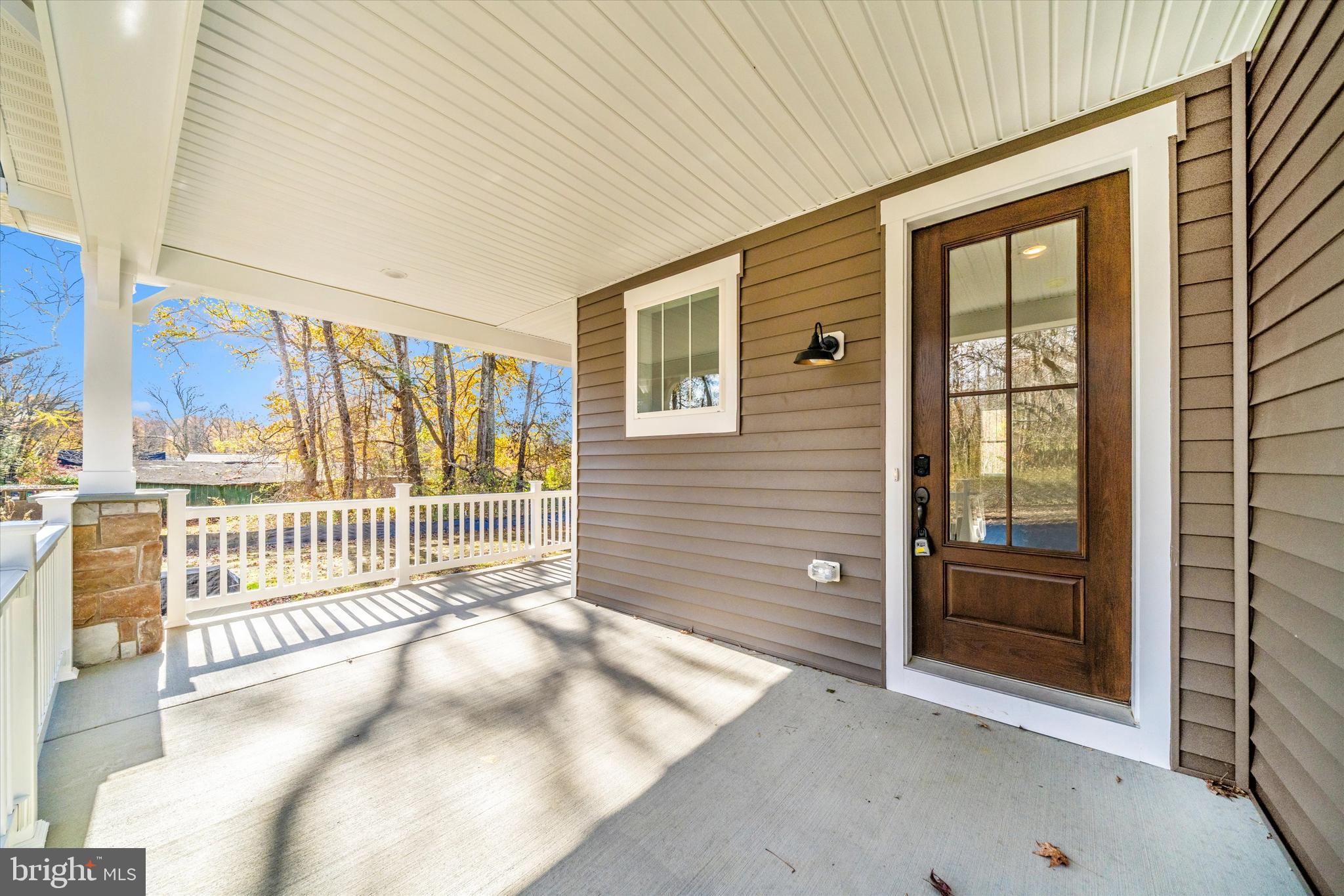 1154 Mt Zion Marlboro Road Lothian, MD 20711 - Photo 48 of 66 a view of a porch with a table and chairs