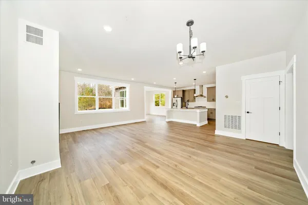 a view of a kitchen with wooden floor and a kitchen space