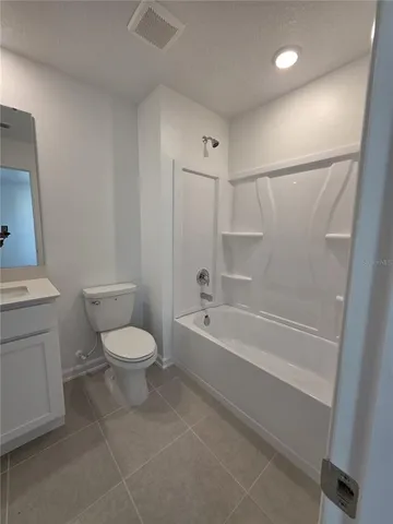 a bathroom with a toilet and a bathtub