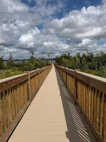 a balcony with wooden floor and lake view