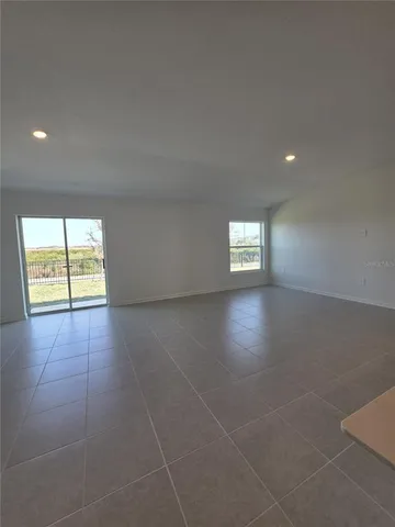 a view of an empty room and a window