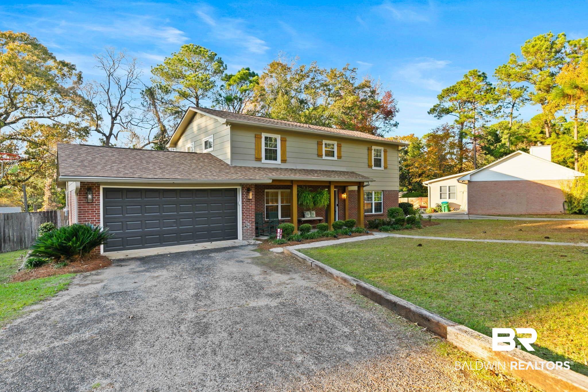 608 Southern Way Daphne, AL 36527 - Photo 2 of 35 Traditional-style home featuring brick siding, driveway, a porch, and an attached garage