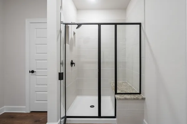 a bathroom with a glass shower door