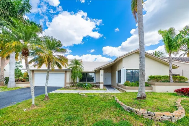a front view of a house with a yard and porch
