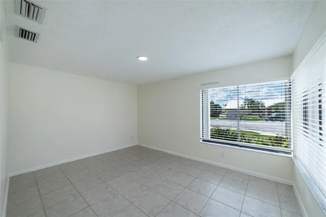 a view of a swimming pool with a patio and a yard