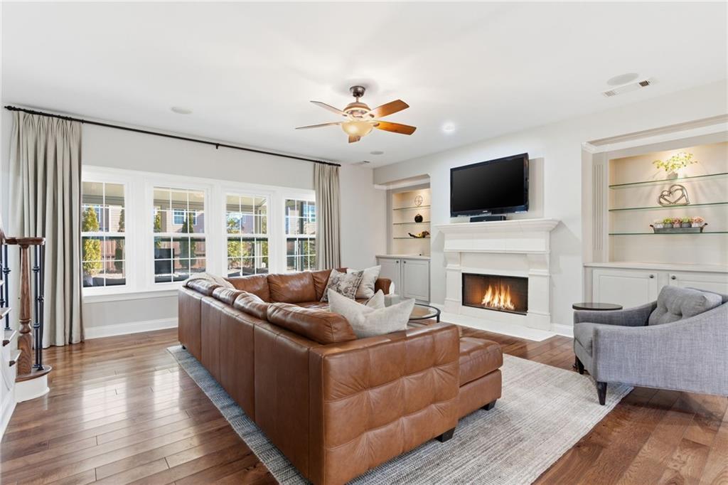 4415 Brampton Way Cumming, GA 30041 - Photo 14 of 59 a living room with furniture a fireplace and a flat screen tv