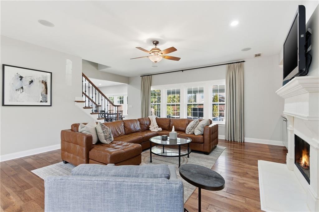 4415 Brampton Way Cumming, GA 30041 - Photo 15 of 59 a living room with furniture a fireplace and a flat screen tv