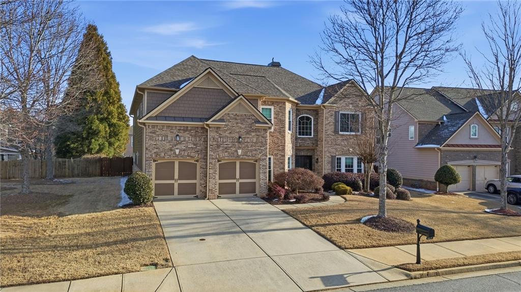 4415 Brampton Way Cumming, GA 30041 - Photo 2 of 59 a front view of a house with garden