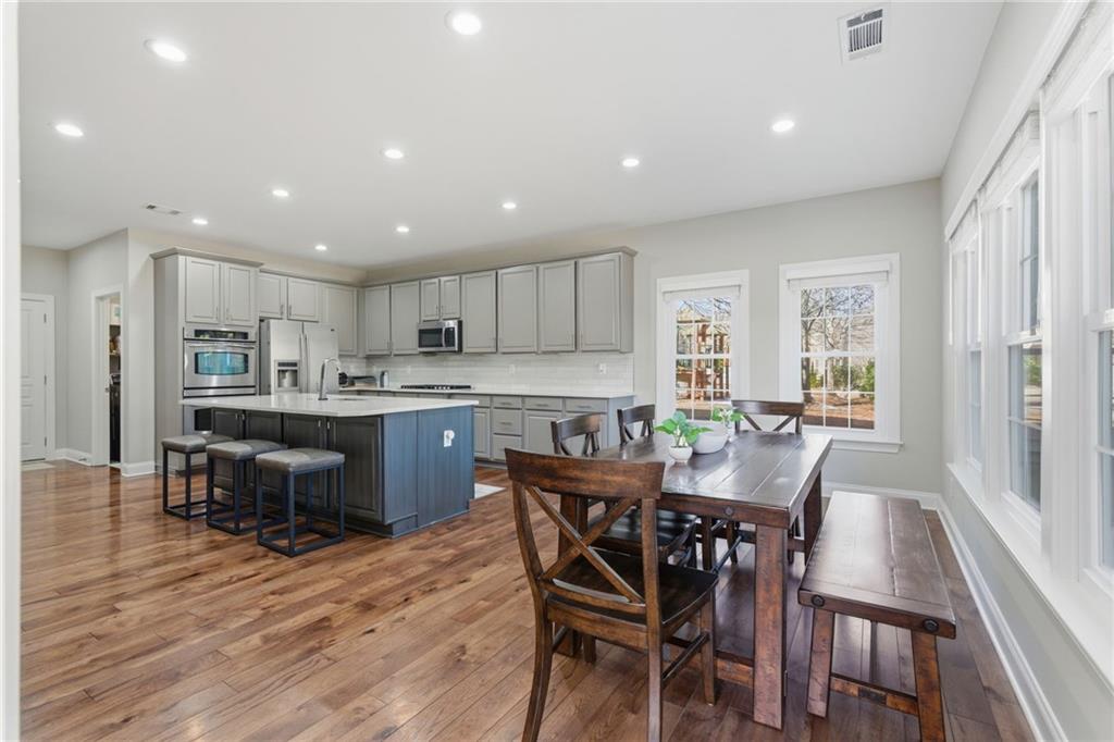 4415 Brampton Way Cumming, GA 30041 - Photo 25 of 59 a view of a dining room with furniture a kitchen and chandelier