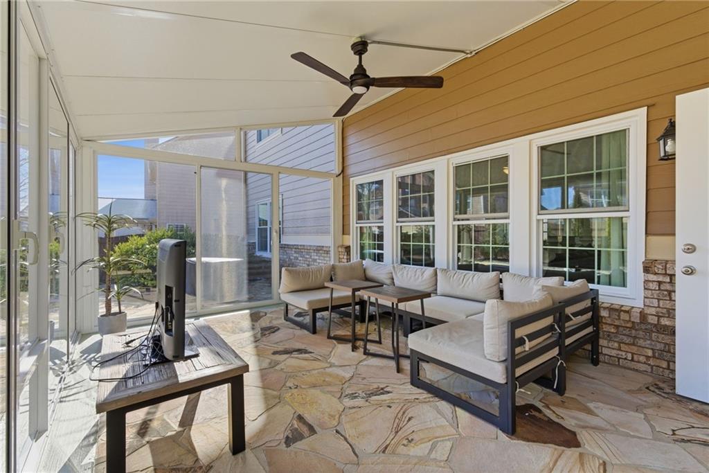 4415 Brampton Way Cumming, GA 30041 - Photo 27 of 59 a living room with furniture and floor to ceiling windows
