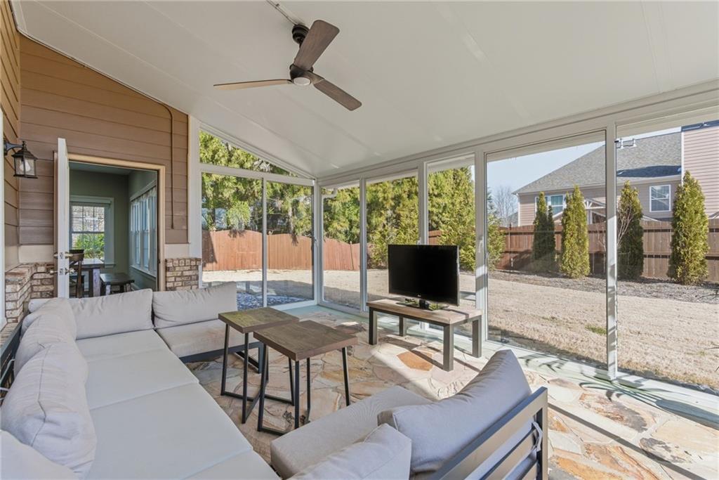 4415 Brampton Way Cumming, GA 30041 - Photo 28 of 59 a living room with furniture a flat screen tv and a large window