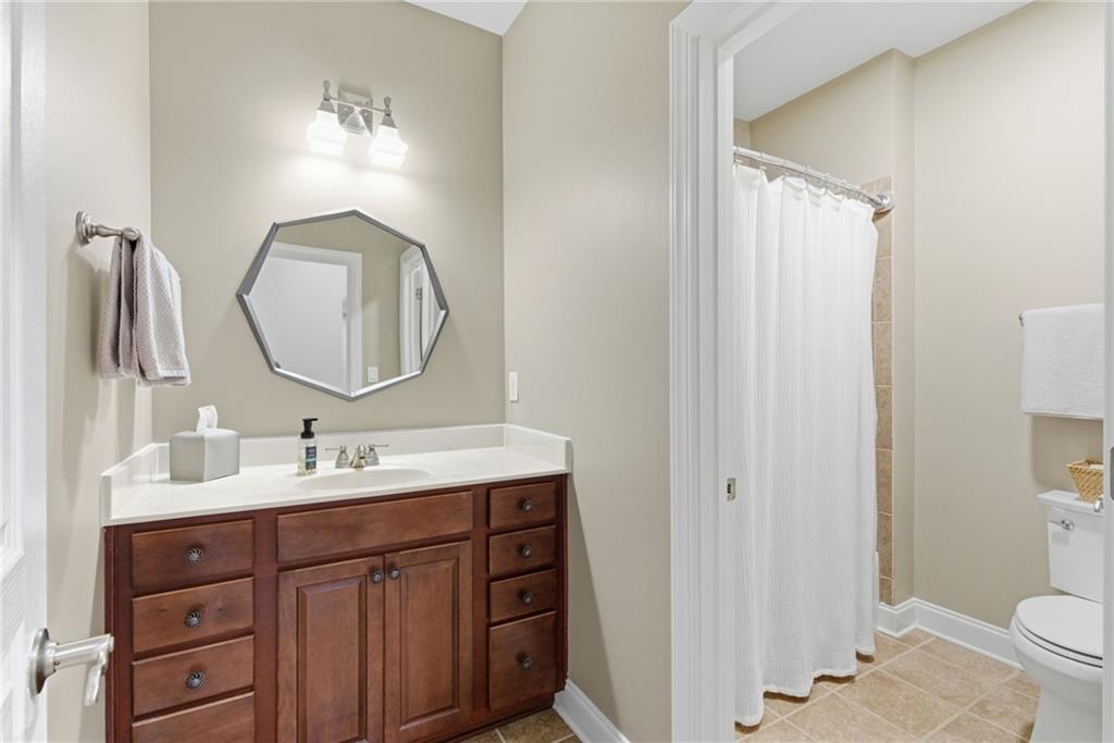 4415 Brampton Way Cumming, GA 30041 - Photo 30 of 59 a bathroom with a double vanity sink and a mirror