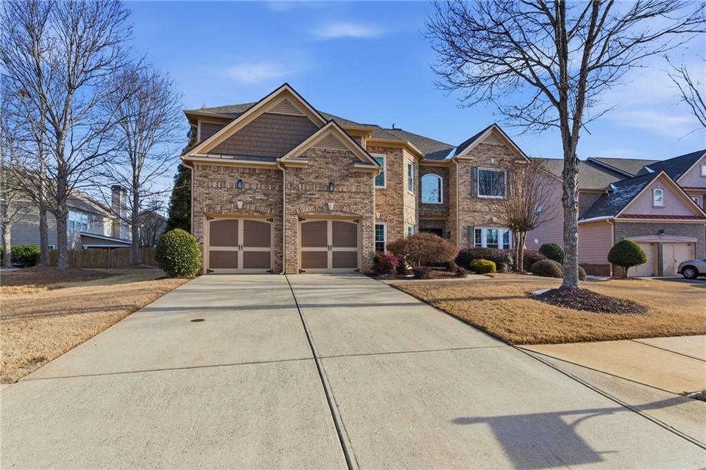 4415 Brampton Way Cumming, GA 30041 - Photo 3 of 59 a front view of a house with garden