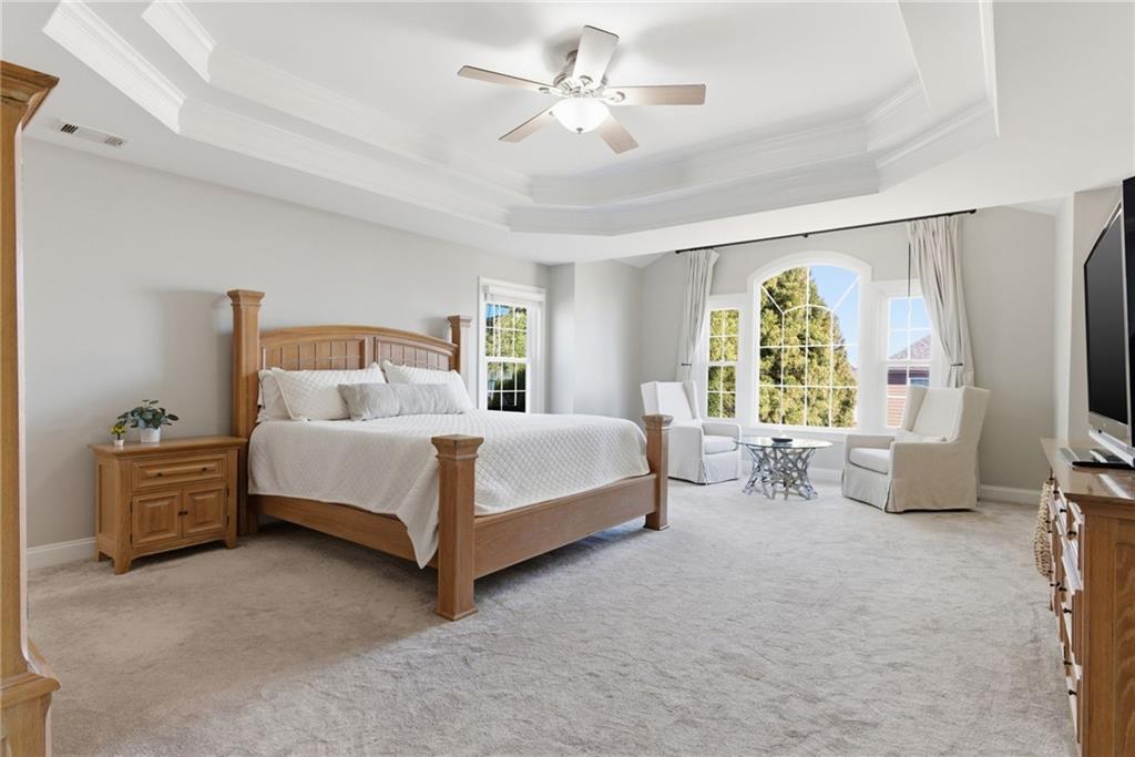 4415 Brampton Way Cumming, GA 30041 - Photo 32 of 59 a bed room with a bed and a chandelier