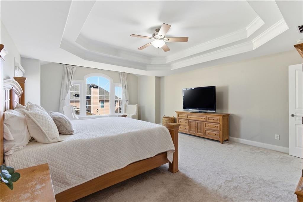 4415 Brampton Way Cumming, GA 30041 - Photo 33 of 59 a bedroom with a bed and a flat screen tv