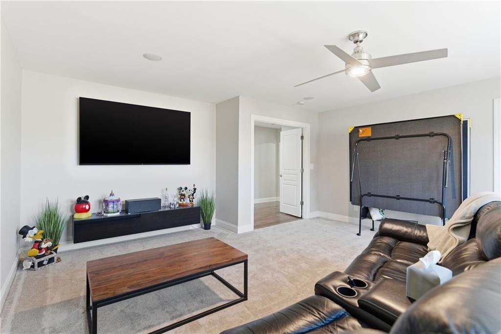 4415 Brampton Way Cumming, GA 30041 - Photo 42 of 59 a living room with furniture and a flat screen tv