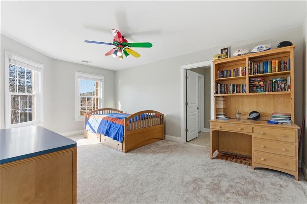 4415 Brampton Way Cumming, GA 30041 - Photo 43 of 59 a bedroom with a bed and a book shelf