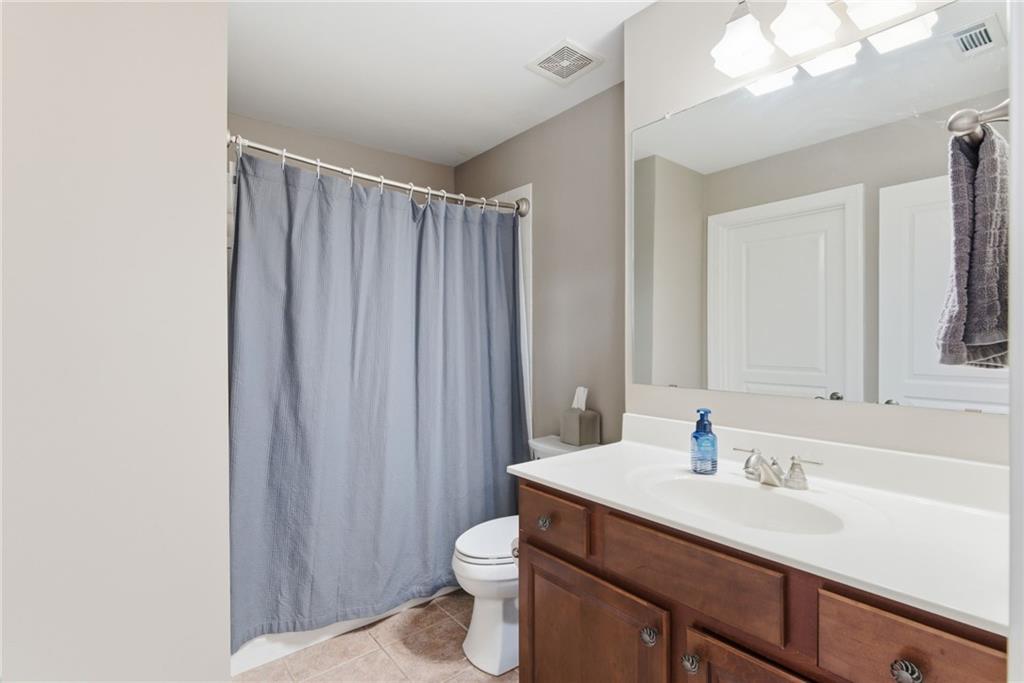 4415 Brampton Way Cumming, GA 30041 - Photo 44 of 59 a bathroom with a sink vanity mirror and toilet