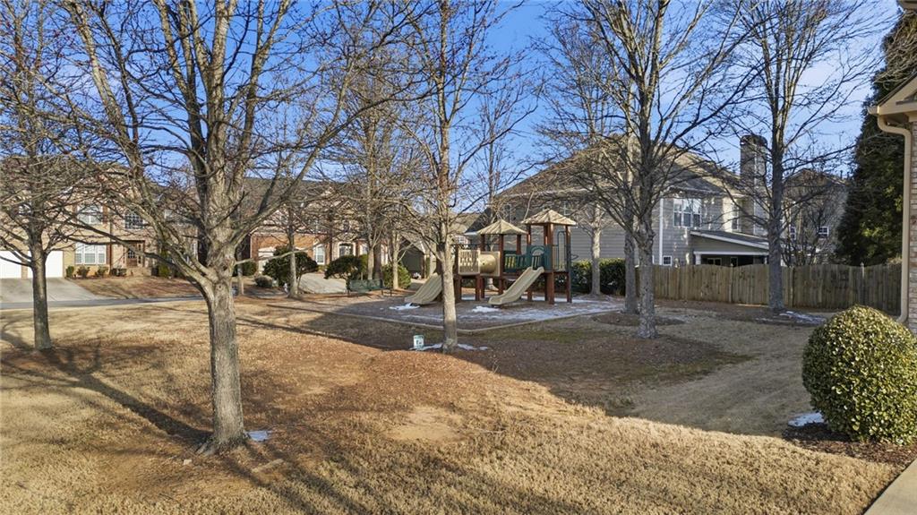 4415 Brampton Way Cumming, GA 30041 - Photo 47 of 59 a street view with large trees