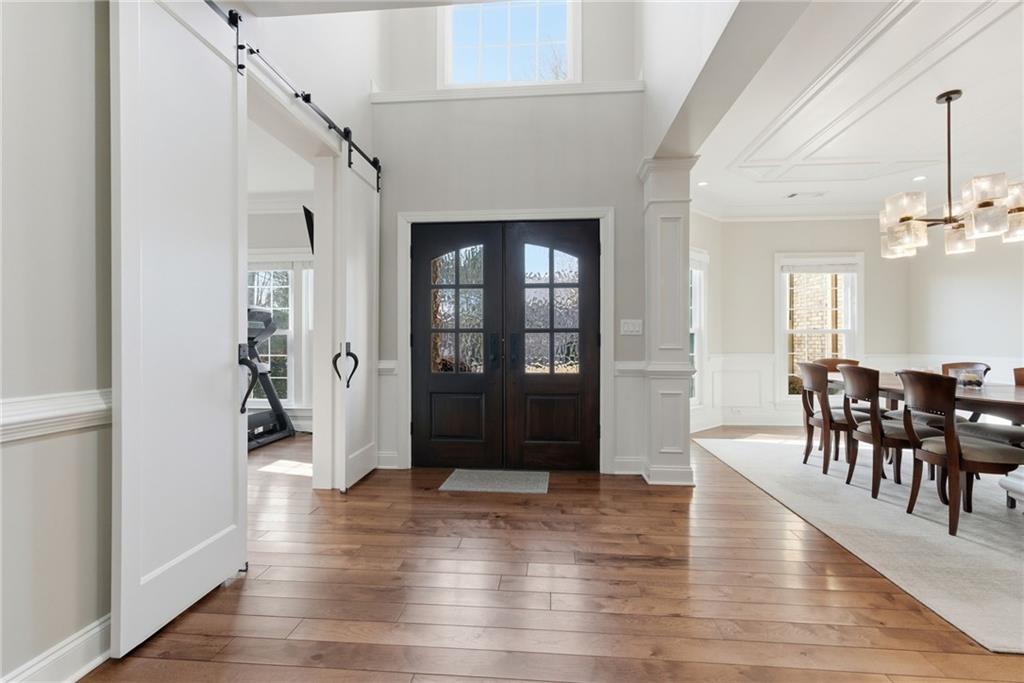 4415 Brampton Way Cumming, GA 30041 - Photo 7 of 59 a view of a hallway with wooden floor and dining room