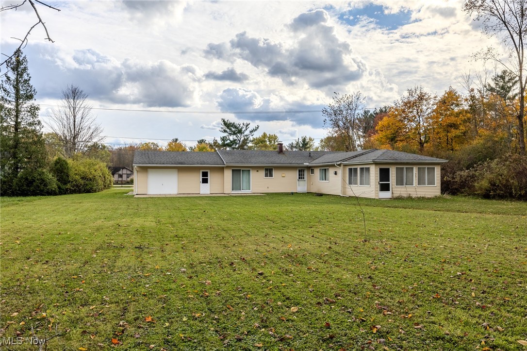 8226 Cedar Road Chesterland, OH 44026 - Photo 7 of 46 Back of house featuring a lawn and a chimney