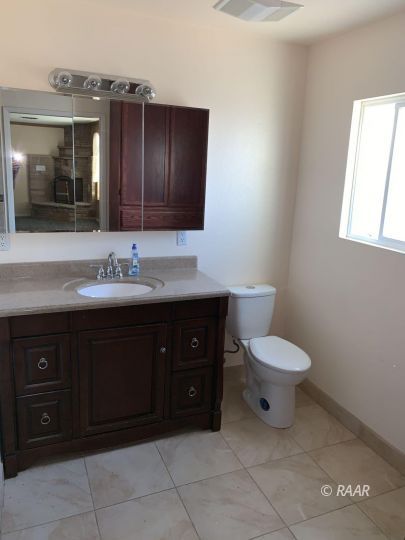 600 South Nevada Street Ridgecrest, CA 93555 - Photo 16 of 30 a bathroom with a toilet sink and mirror