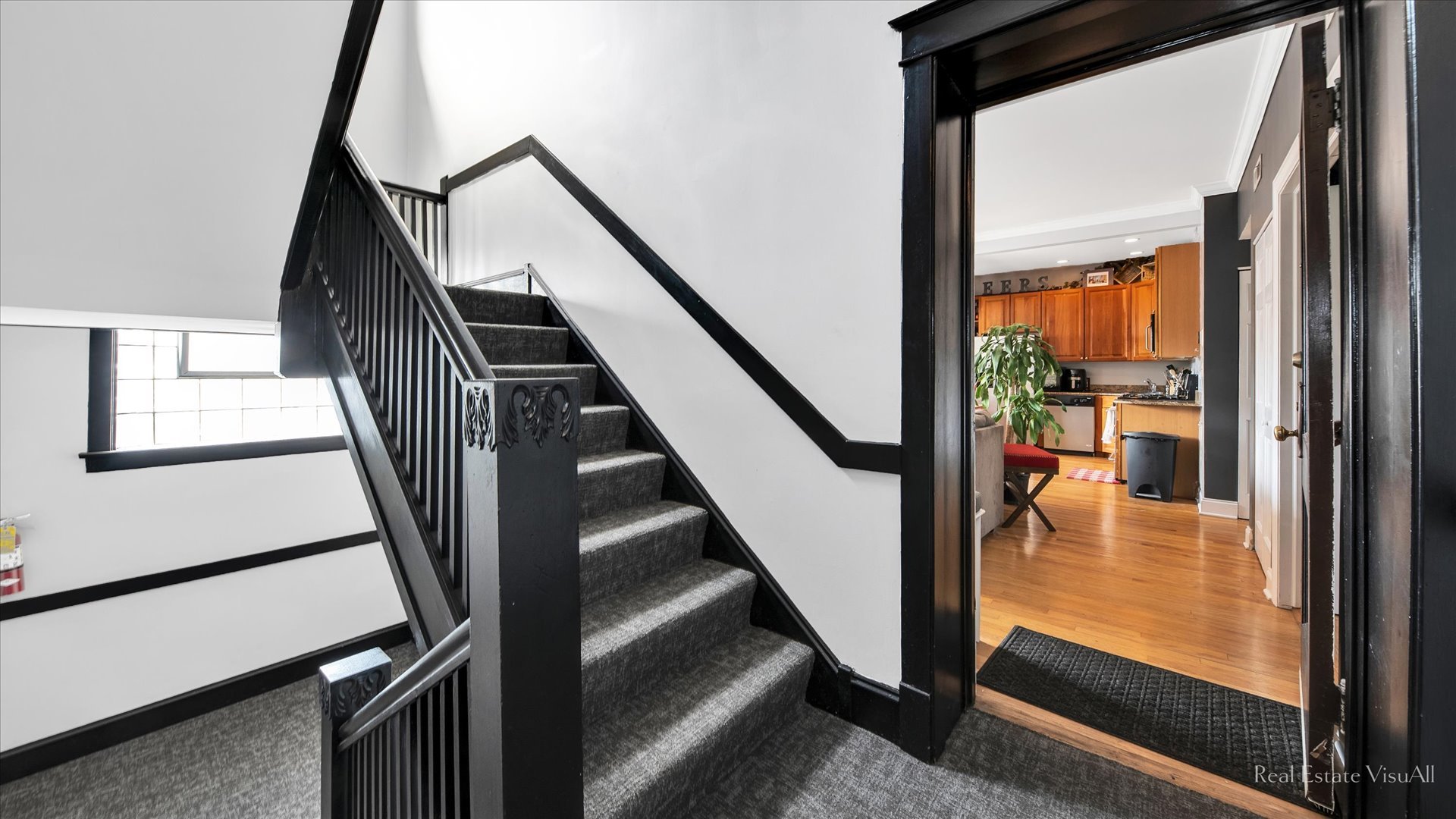 1340 West Irving Park Road, Unit 2 Chicago, IL 60613 - Photo 2 of 25 a view of staircase with wooden floor and a window