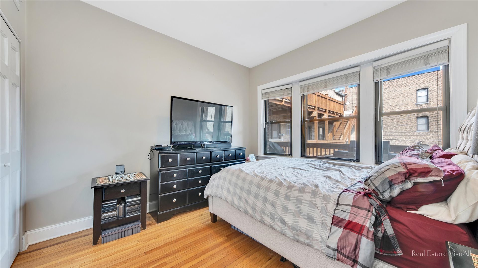 1340 West Irving Park Road, Unit 2 Chicago, IL 60613 - Photo 11 of 25 a bedroom with a bed and wooden floor