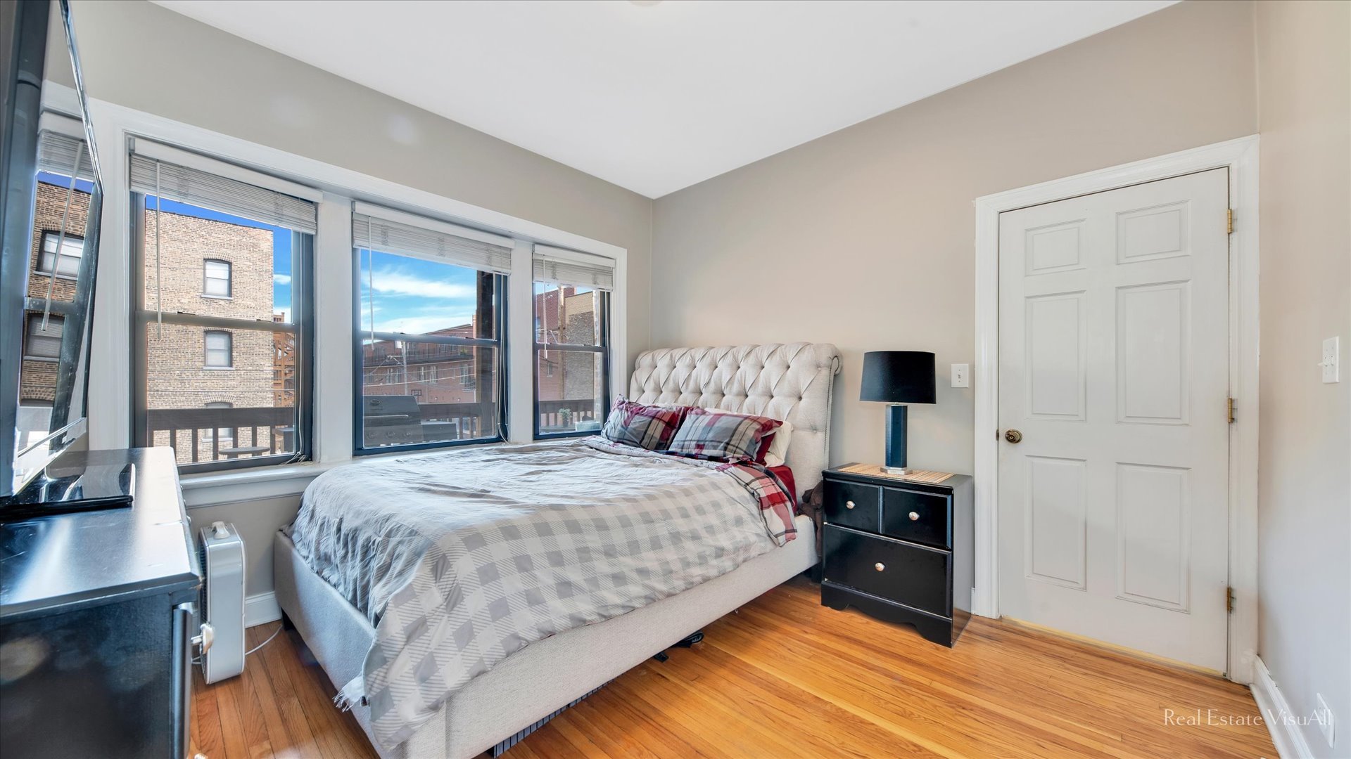 1340 West Irving Park Road, Unit 2 Chicago, IL 60613 - Photo 12 of 25 a bedroom with a bed wooden floor and window