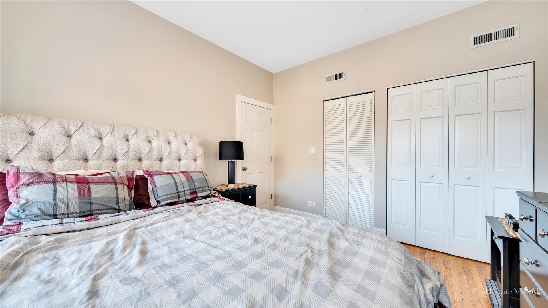 1340 West Irving Park Road, Unit 2 Chicago, IL 60613 - Photo 13 of 25 a bedroom with a bed and lamp