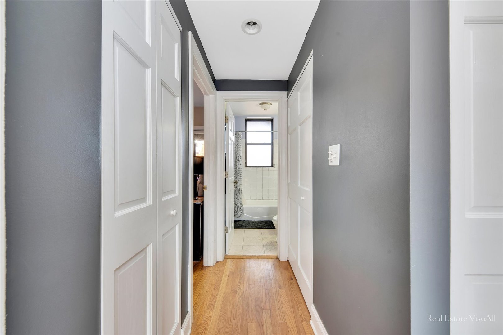 1340 West Irving Park Road, Unit 2 Chicago, IL 60613 - Photo 14 of 25 a view of a hallway with wooden floor and a bathroom