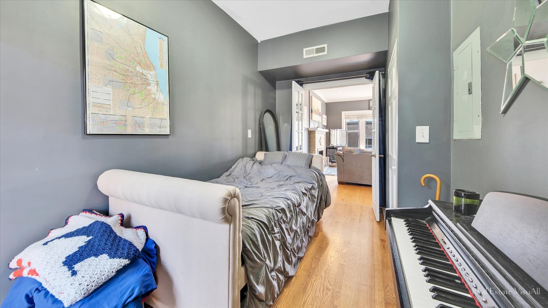 1340 West Irving Park Road, Unit 2 Chicago, IL 60613 - Photo 16 of 25 a bedroom with a bed and wooden floor