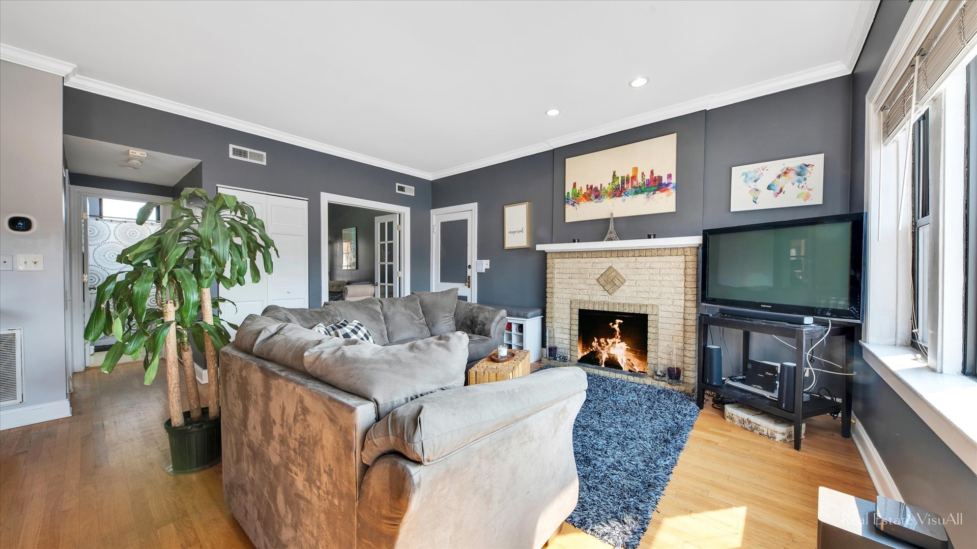 1340 West Irving Park Road, Unit 2 Chicago, IL 60613 - Photo 4 of 25 a living room with furniture a flat screen tv and a fireplace