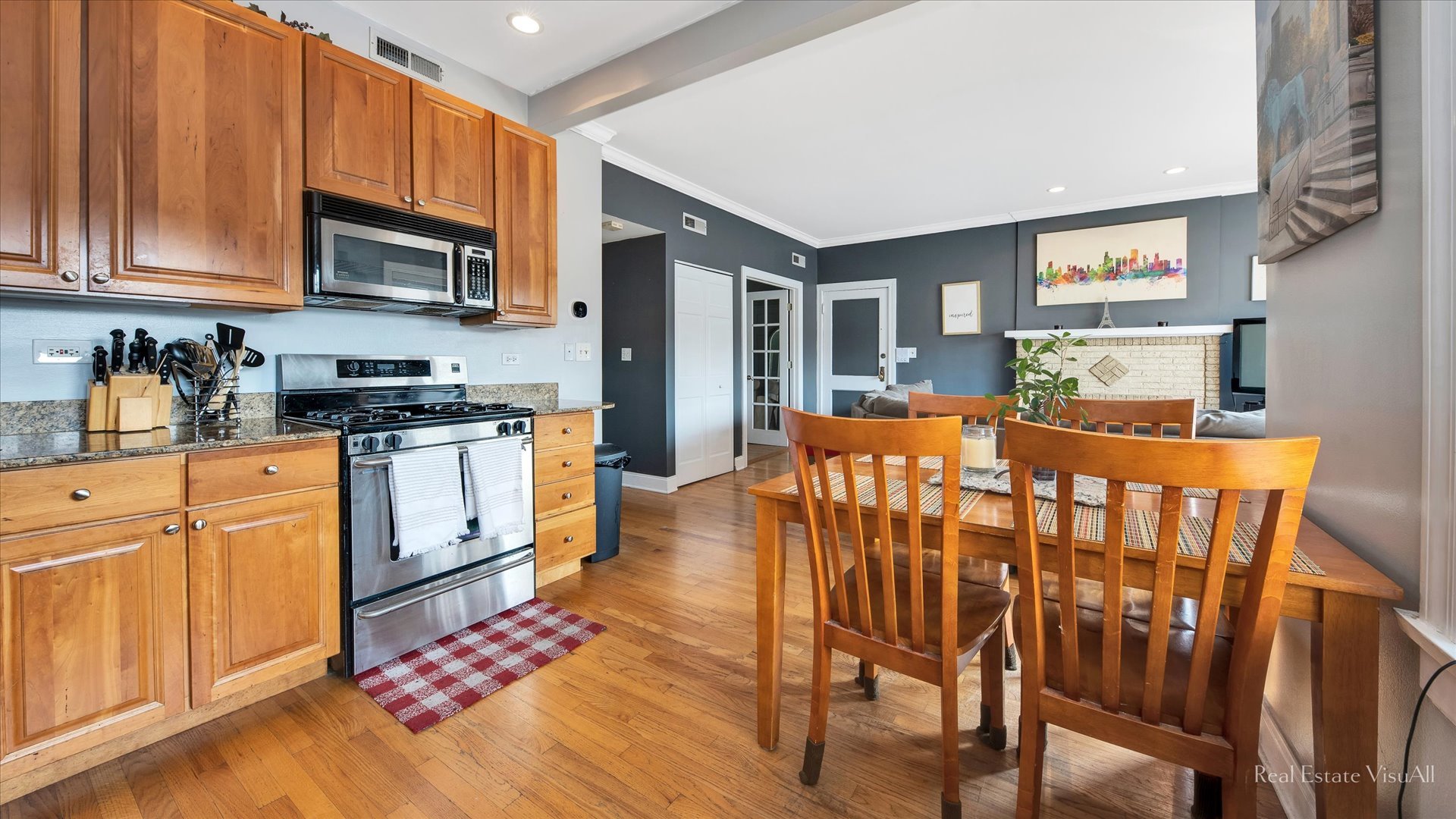 1340 West Irving Park Road, Unit 2 Chicago, IL 60613 - Photo 8 of 25 a open kitchen with stainless steel appliances granite countertop a stove a sink dishwasher and white cabinets with wooden floor