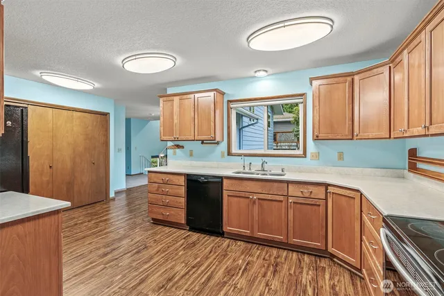 a view of a room with wooden floor and windows