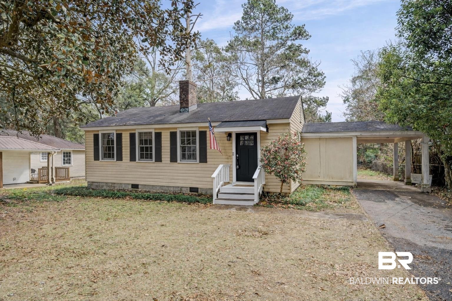 5117 Norton Lane Mobile, AL 36608 - Photo 2 of 35 View of front facade featuring crawl space, an attached carport, a chimney, and driveway