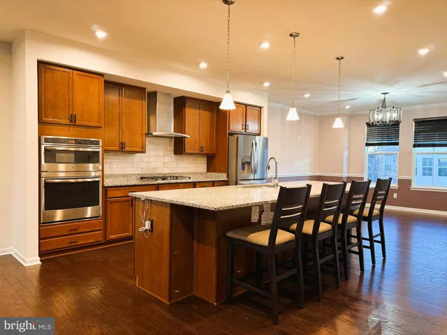 a large kitchen with a table and chairs