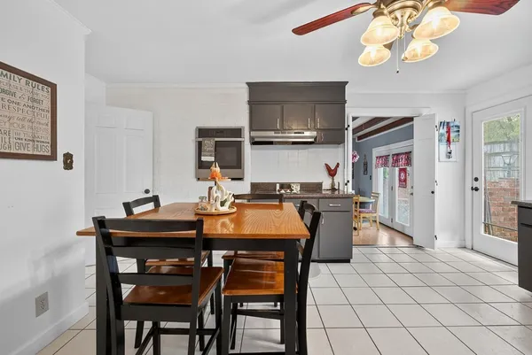 a view of a dining room with furniture and chandelier