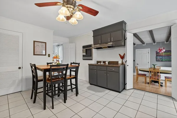 a kitchen with stainless steel appliances granite countertop a stove a sink dishwasher a dining table and chairs with wooden floor