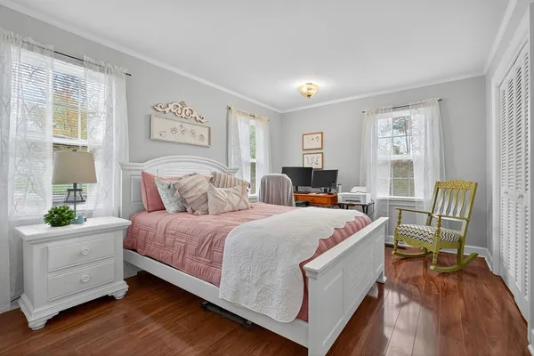 a bed room with a bed and a chair