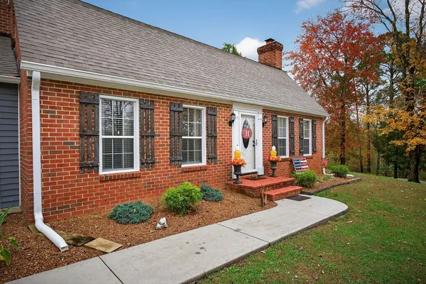 a view of a patio with table and chairs near a yard
