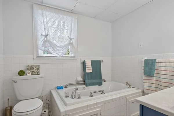 a bathroom with a sink a toilet and a mirror