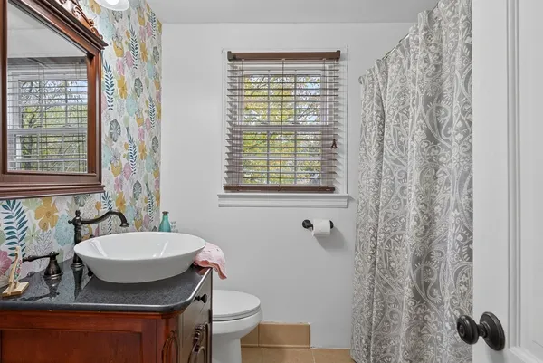 a bathroom with a toilet sink and mirror