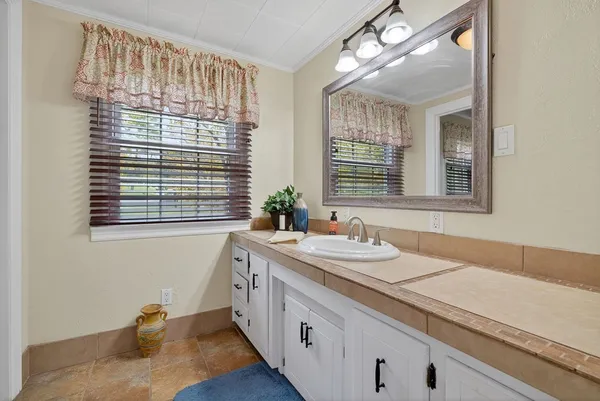 a bathroom with a sink and a window