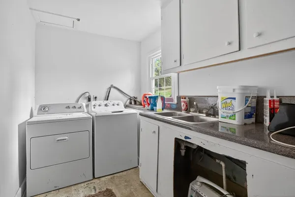 a kitchen with a sink cabinets and appliances