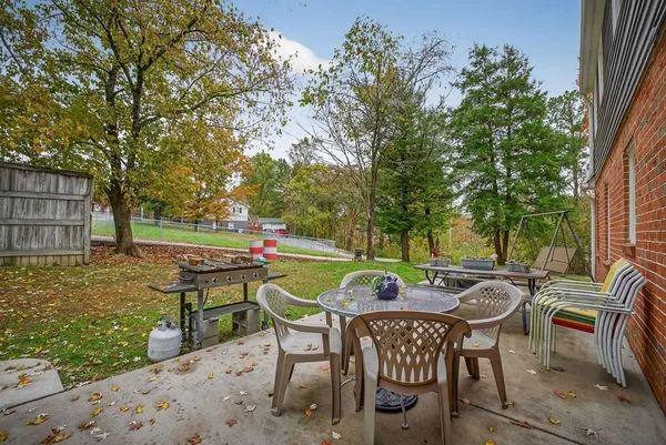 a view of a chairs and table in backyard