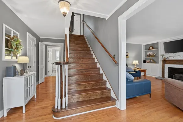 a view of entryway and hall with wooden floor