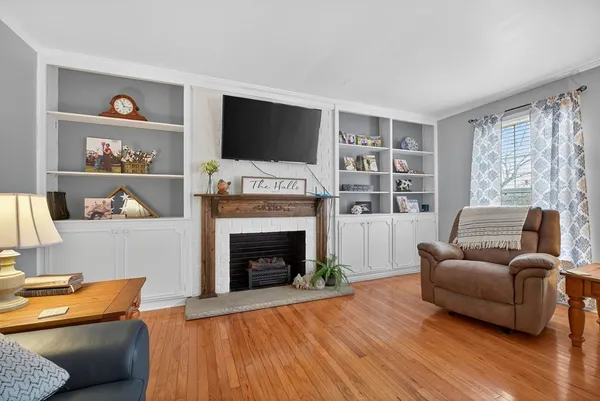 a living room with furniture fireplace and flat screen tv