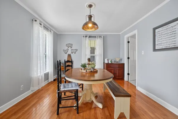 a dining room with furniture and wooden floor